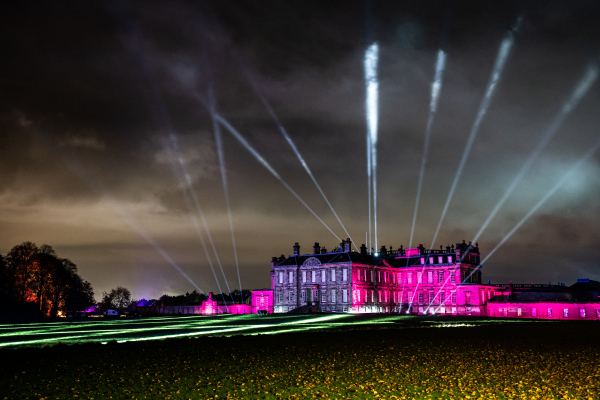 Stately home Hopetoun House illuminated in the dark with pink, purple and whitelights