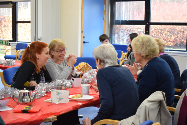Ladies chatting over tea, coffee and cakes.