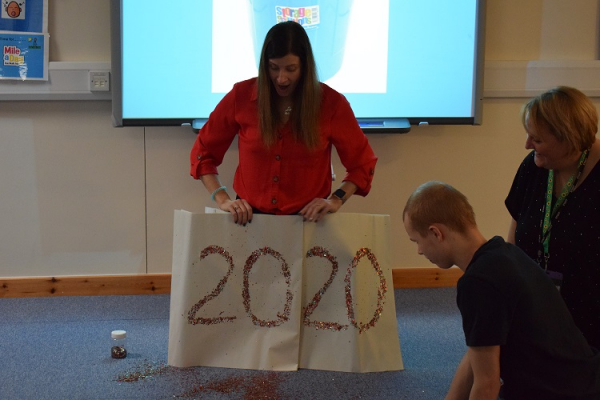 2020 written on white paper with glitter