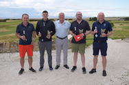 Image is of five people, winners with trophies, outdoors at a golf day