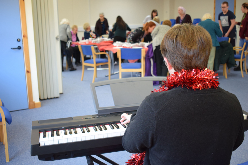Pupil Jack playing keyboard for everyone at the Festive Afternoon Tea 