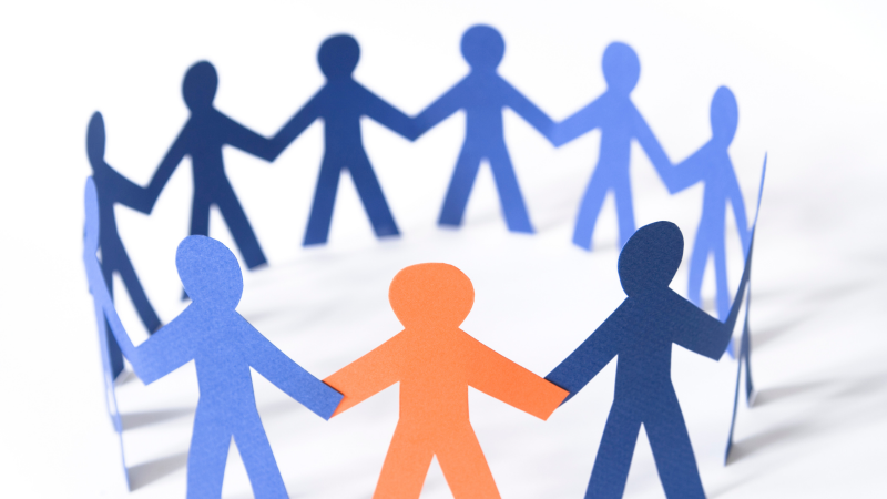 Image if of a paper chain of people connected together