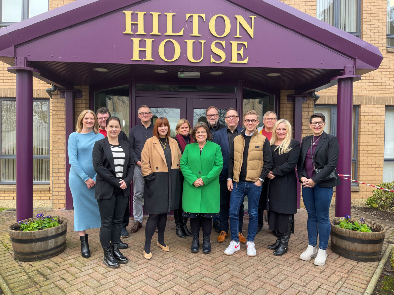 Photograph shows Scottish Autism and Autism Foundation Finland representatives standing outside Hilton House in Alloa