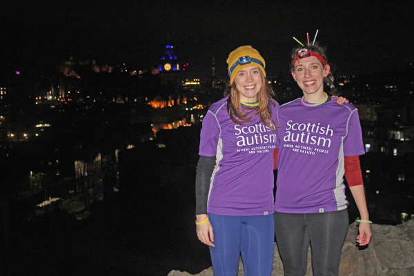 Two fundraisers wearing Scottish Autism supporter t-shirts on Edinburgh's Calton Hill