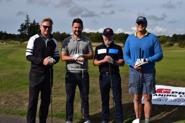 Four golfers, golf course, outdoors in the sunshine