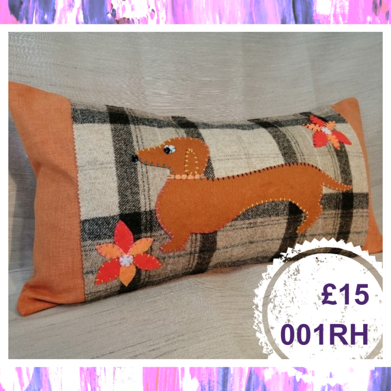 A long cushion with a dog on it, £15, 001RH