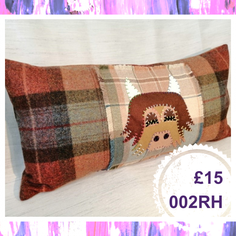 A long cushion with a highland cow, £15, 002RH