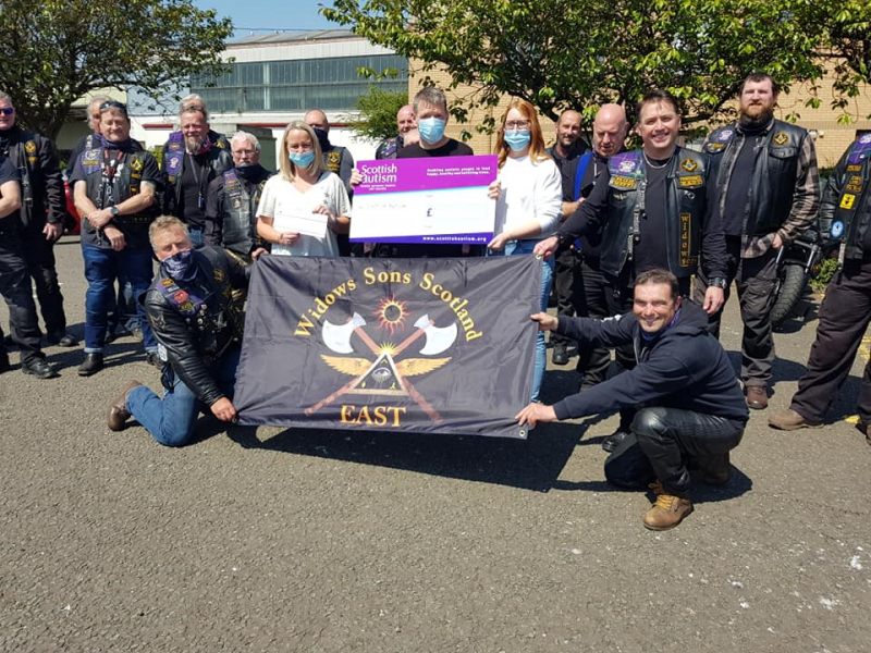 A group of bikers making a donation to Scottish Autism