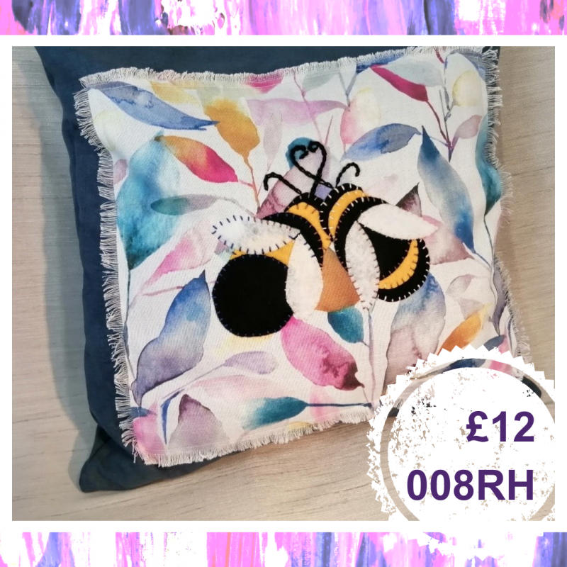 A medium square cushion with a flower and bee, £12, 008RH
