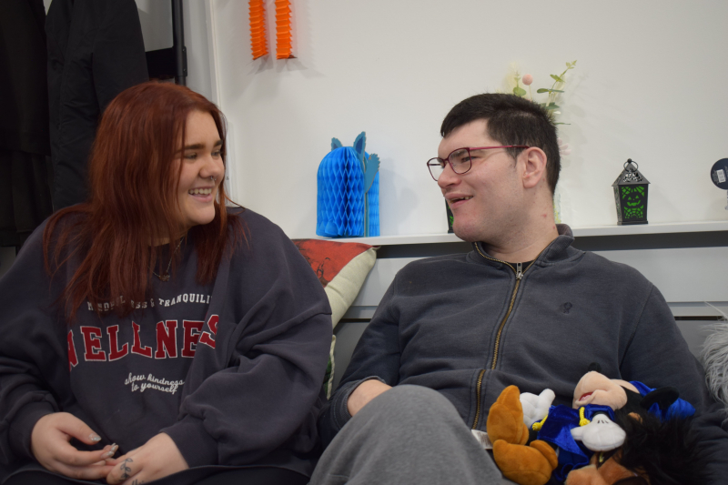 Two people sitting together on a sofa