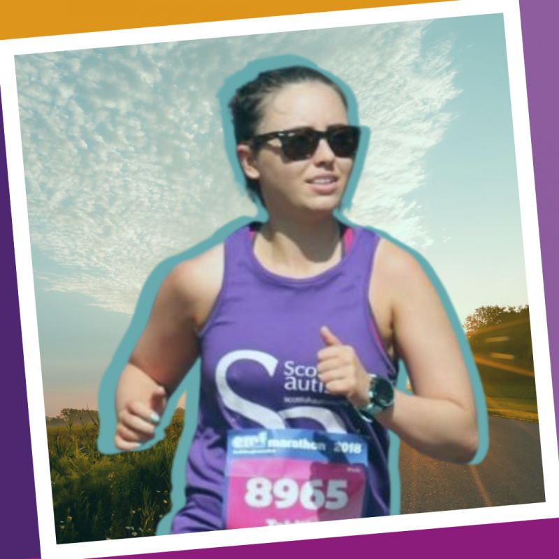 A woman jogs while wearing a purple Scottish Autism supporter vest and sunglasses