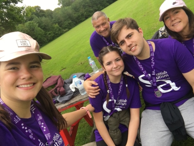 A group of supporters in Scottish Autism purple tshirts take a selfie outdoors