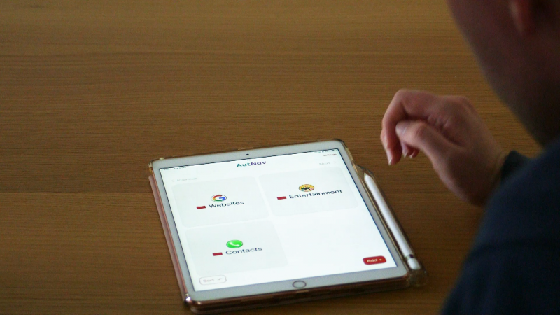 Image is of a person using an application on a tablet device