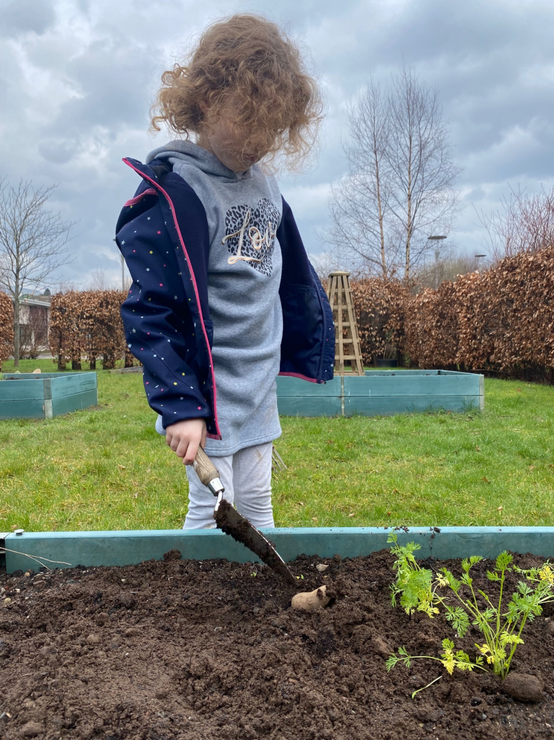 Young person gardening, planter, outdoors