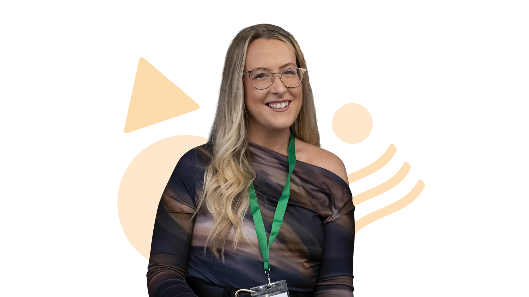 Image is of a person smiling at the camera, wearing a green lanyard