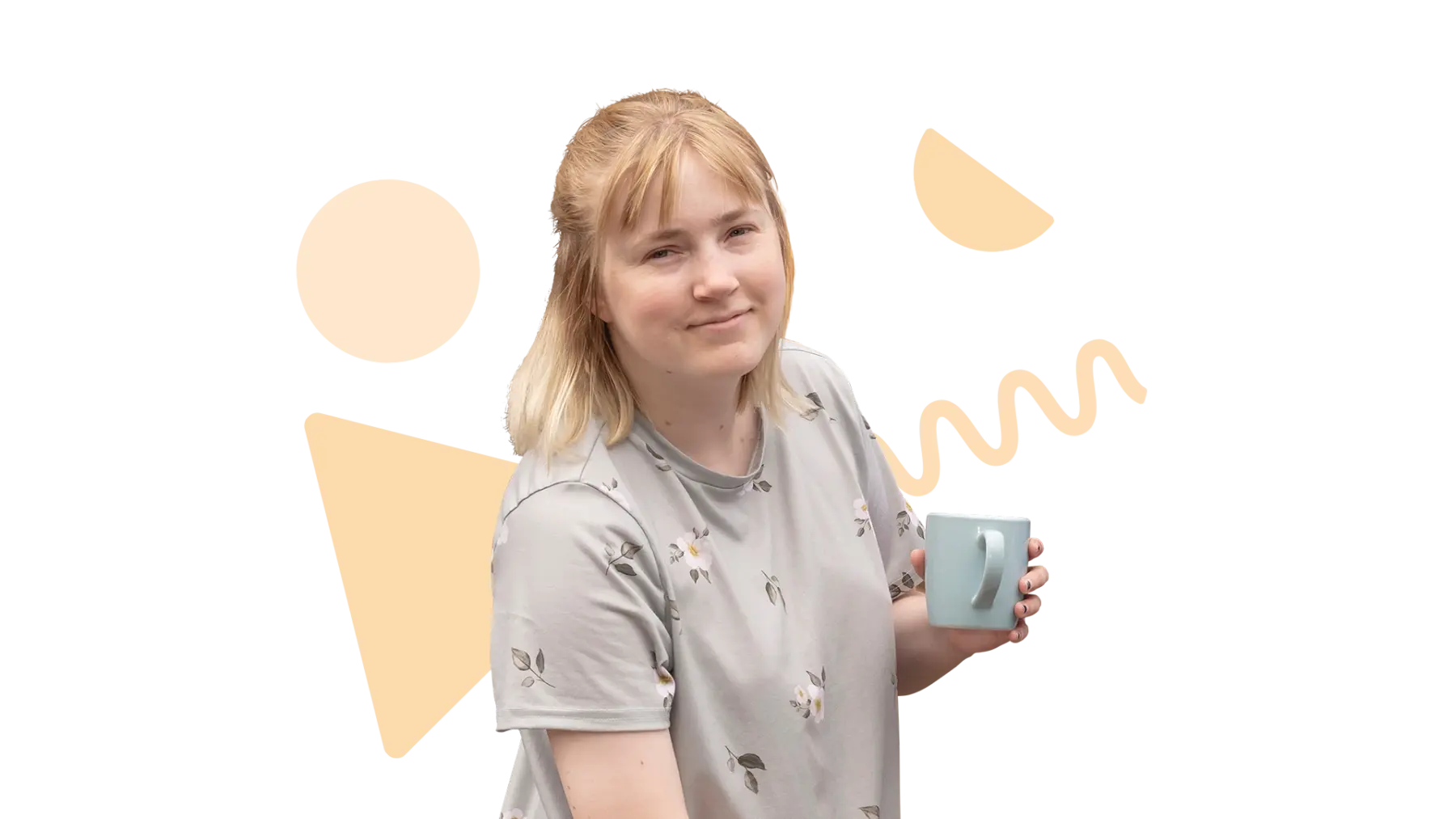 A person holding a mug and smiling for the camera