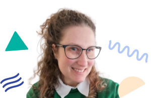 Image is of Practice Advisor Linzi, wearing glasses, light brown curly hair and smiling for the camera