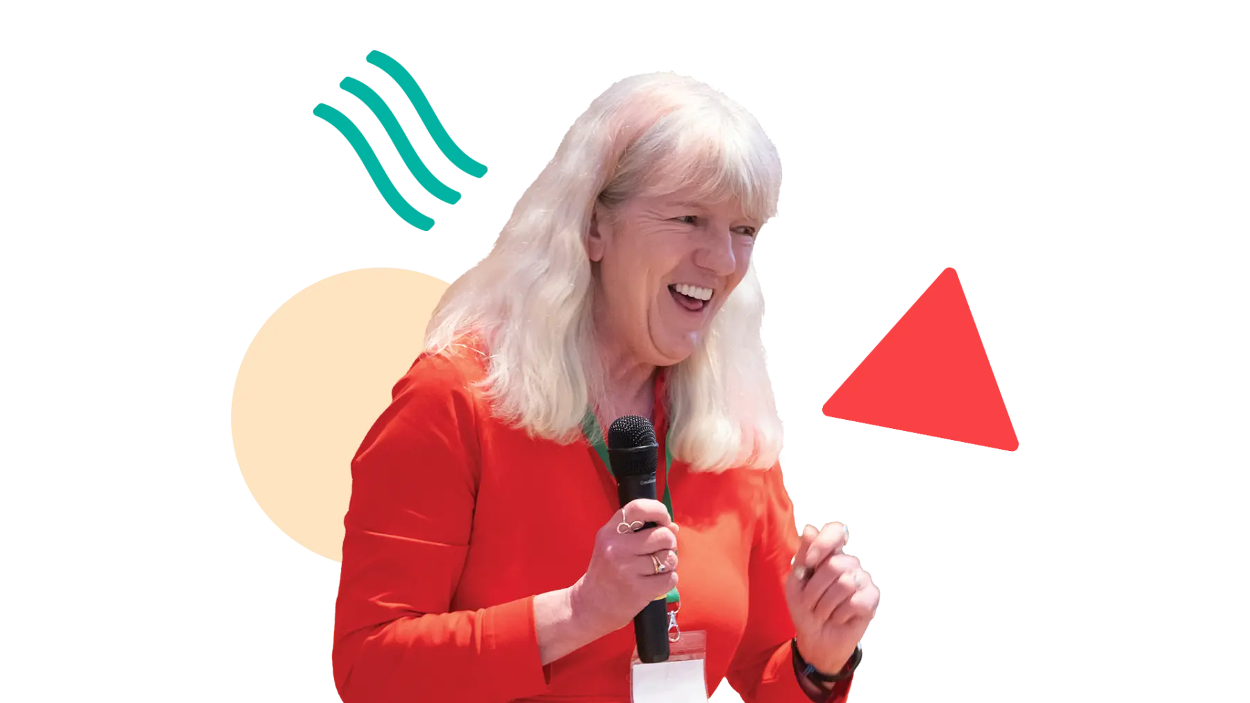 Image is of someone smiling and talking while holding a microphone