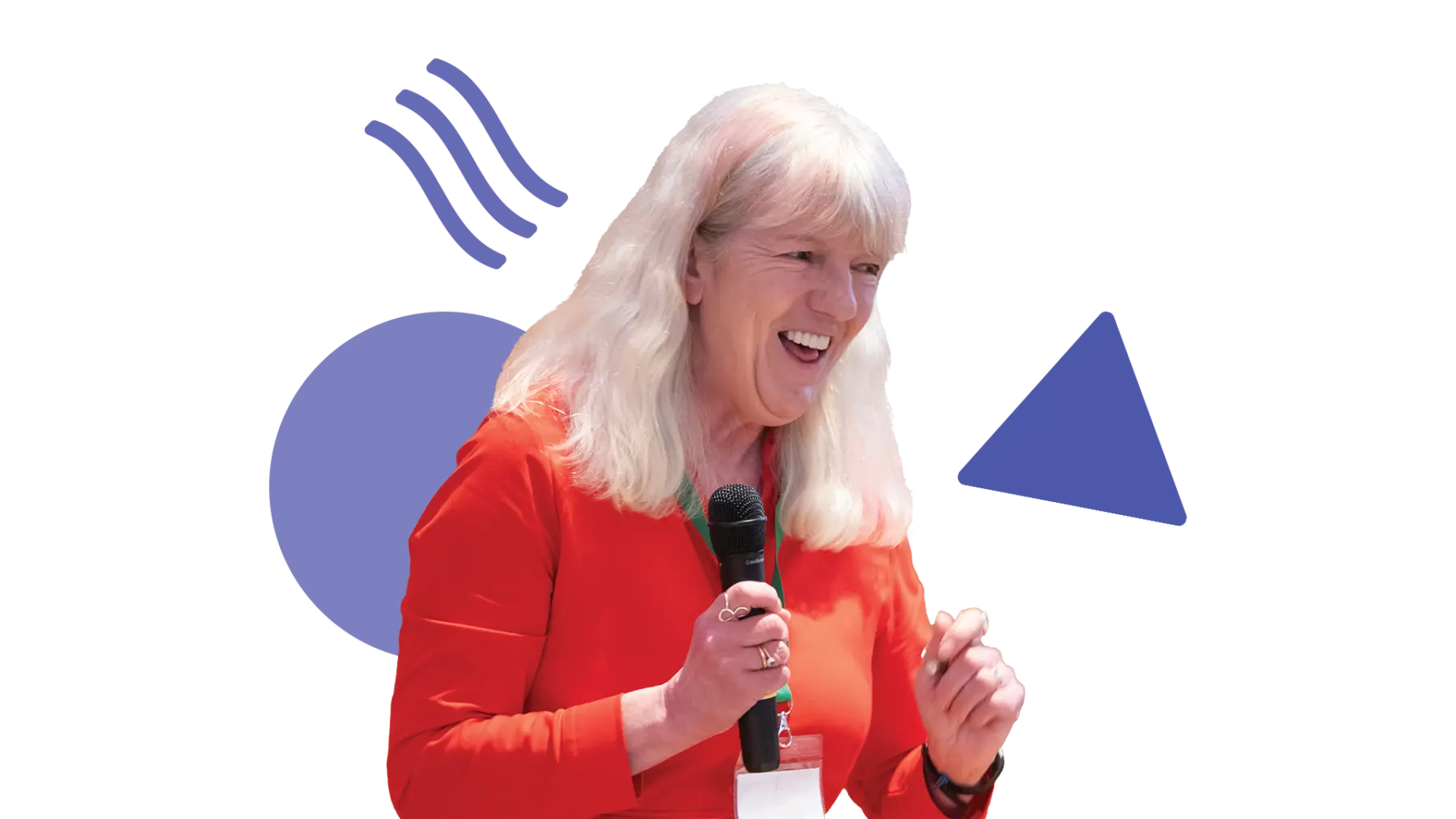 Image is of someone smiling and talking while holding a microphone