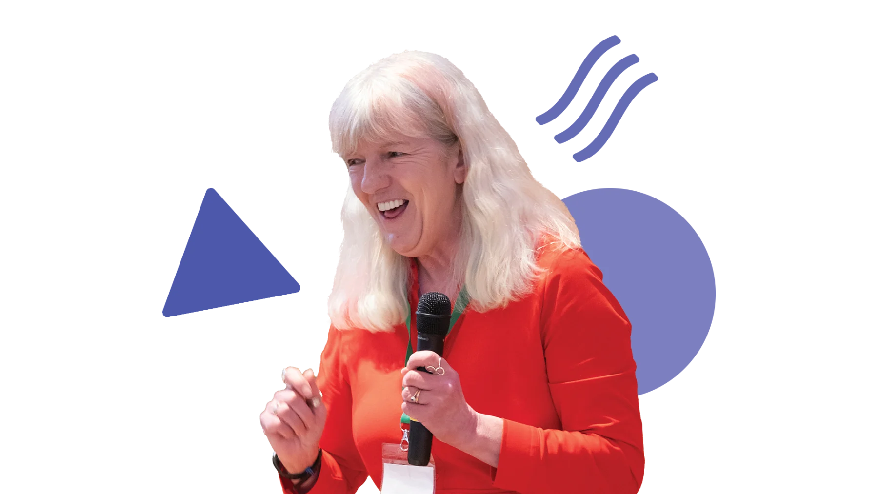 Image is of someone smiling and talking while holding a microphone