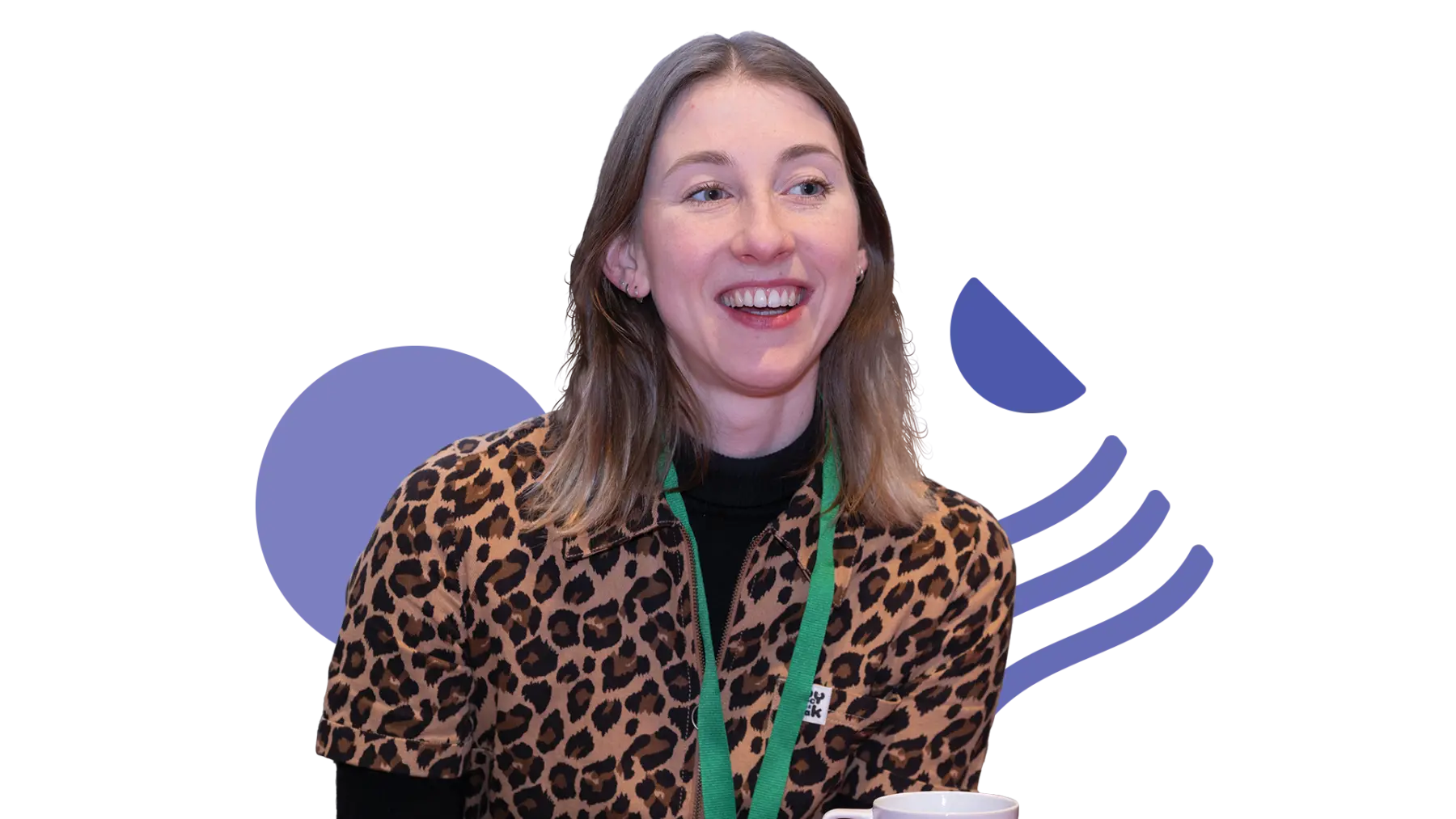 Image is of a person laughing and wearing a green lanyard