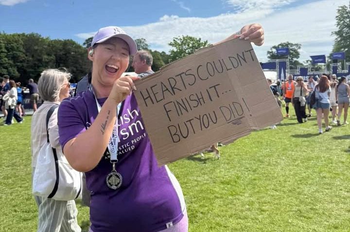 Image of a Scottish Autism supporter with a big smile having completed the Edinburgh Marathon