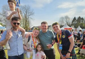 A group of Kiltwalk walk supporters come together and smile for the camera
