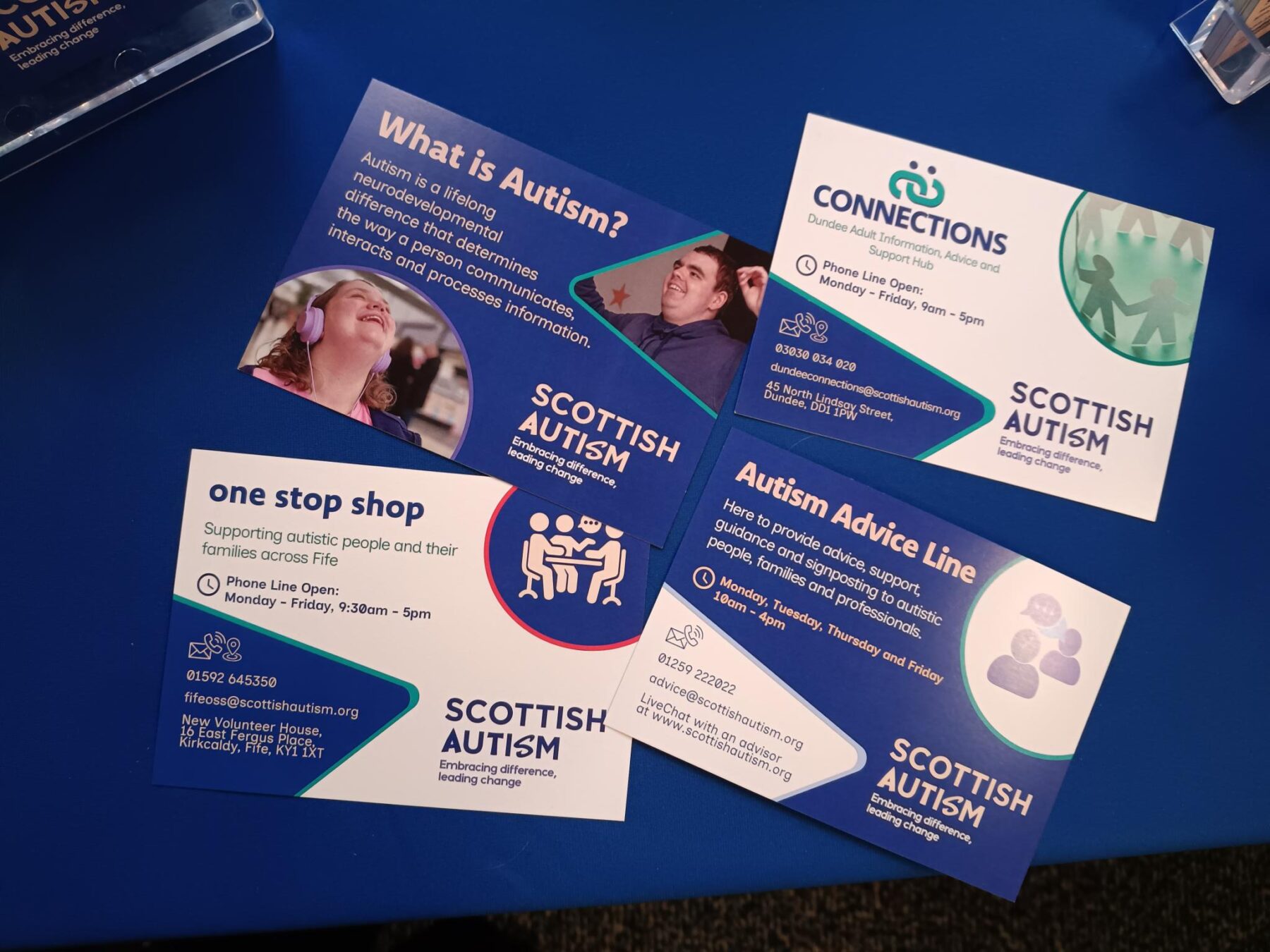 A table with 4 information postcards spread in a neat arrangement